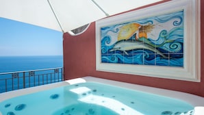 A hot tub with a view of the ocean, a tiled mural with a mermaid, and a balcony railing. - Villa 'Luxury  Soleluna Con Jacuzzi' with Sea View, Wi-Fi and Air Conditioning (Praiano)