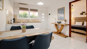 Une cuisine moderne avec un coin repas, une table en bois et des chaises.