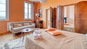 Ein Zimmer mit einem Bett, einem Schlafsofa, einem kleinen Tisch und einem Kleiderschrank.