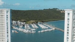 A high-rise building with a marina and a swimming pool. - Condo with Amazing Ocean View in Fajardo near Villa Marina (Fajardo)