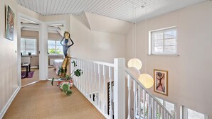 A staircase with a railing, a potted plant, and a painting on the wall. - 2 bedroom nice home in Hemmet (Hemmet)