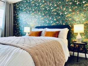 A bed with a quilted cover, two pillows, and a nightstand with a lamp. - Close to M62 Smart TV Parking and Pets Stay Free (Liversedge)