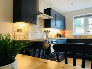 Enjoy cooking in this well-equipped kitchen with a dining area and natural light.