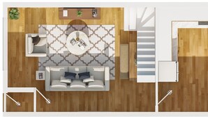 Un salon moderne avec un canapé, une table basse et un tapis à motifs.