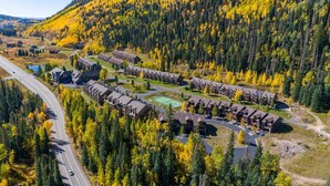 A resort with multiple chalet-style buildings, a tennis court, and a road curving through the property. - Hot Tub & Pool, Pickle Ball, Hiking/Fishing Close! (Durango)