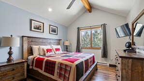 A bedroom with a wooden bed, two bedside tables, a ceiling fan, a window with curtains, and a dresser. - Hot Tub & Pool, Pickle Ball, Hiking/Fishing Close! (Durango)