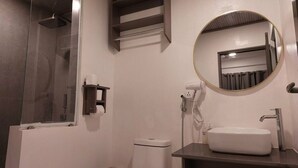 A bathroom with a shower, toilet, sink, and a mirror. - Nirili Villa (Dhiffushi)