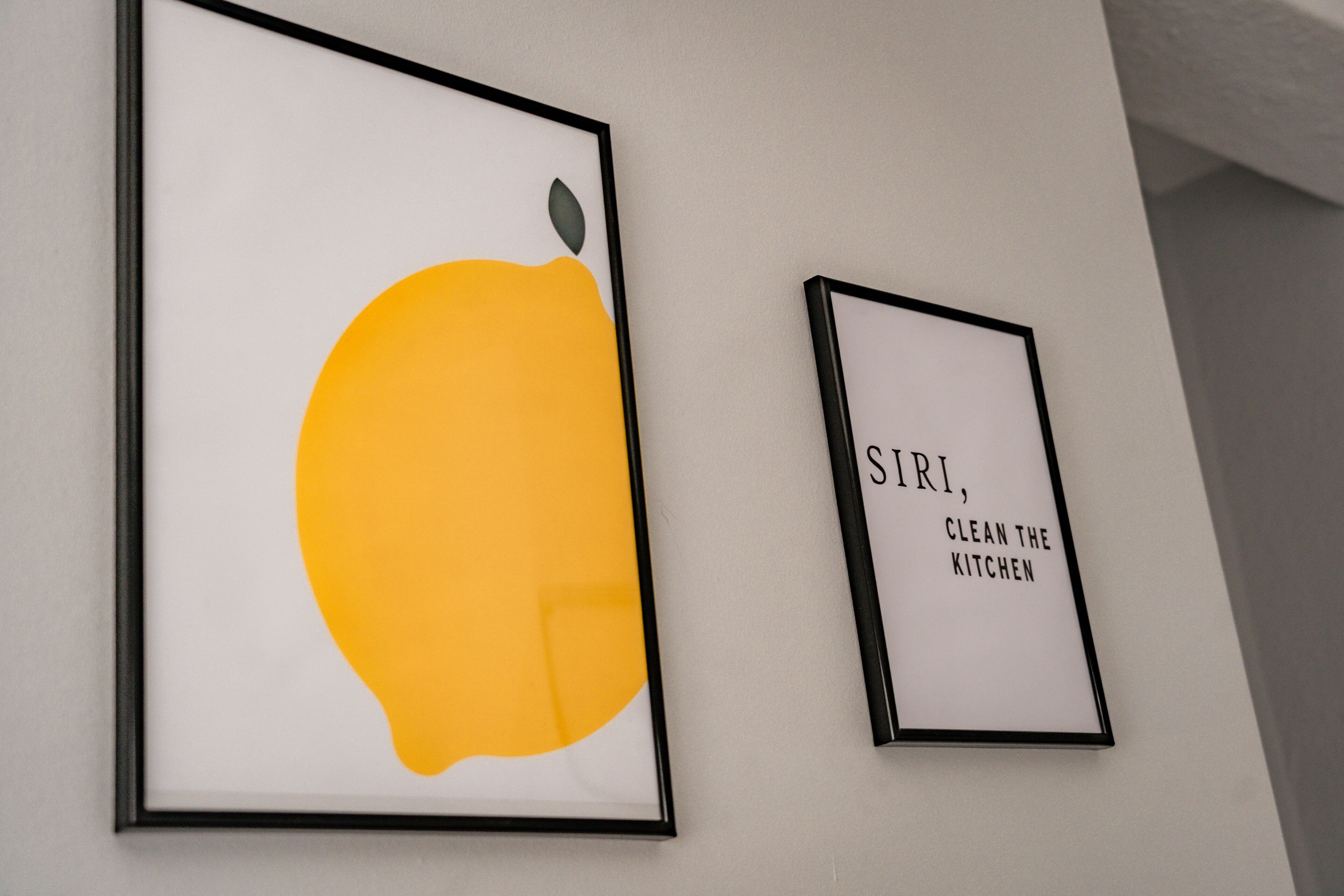 Two framed artworks on a wall.