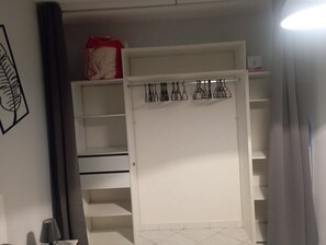 Ample storage space with shelves and hanging rods.