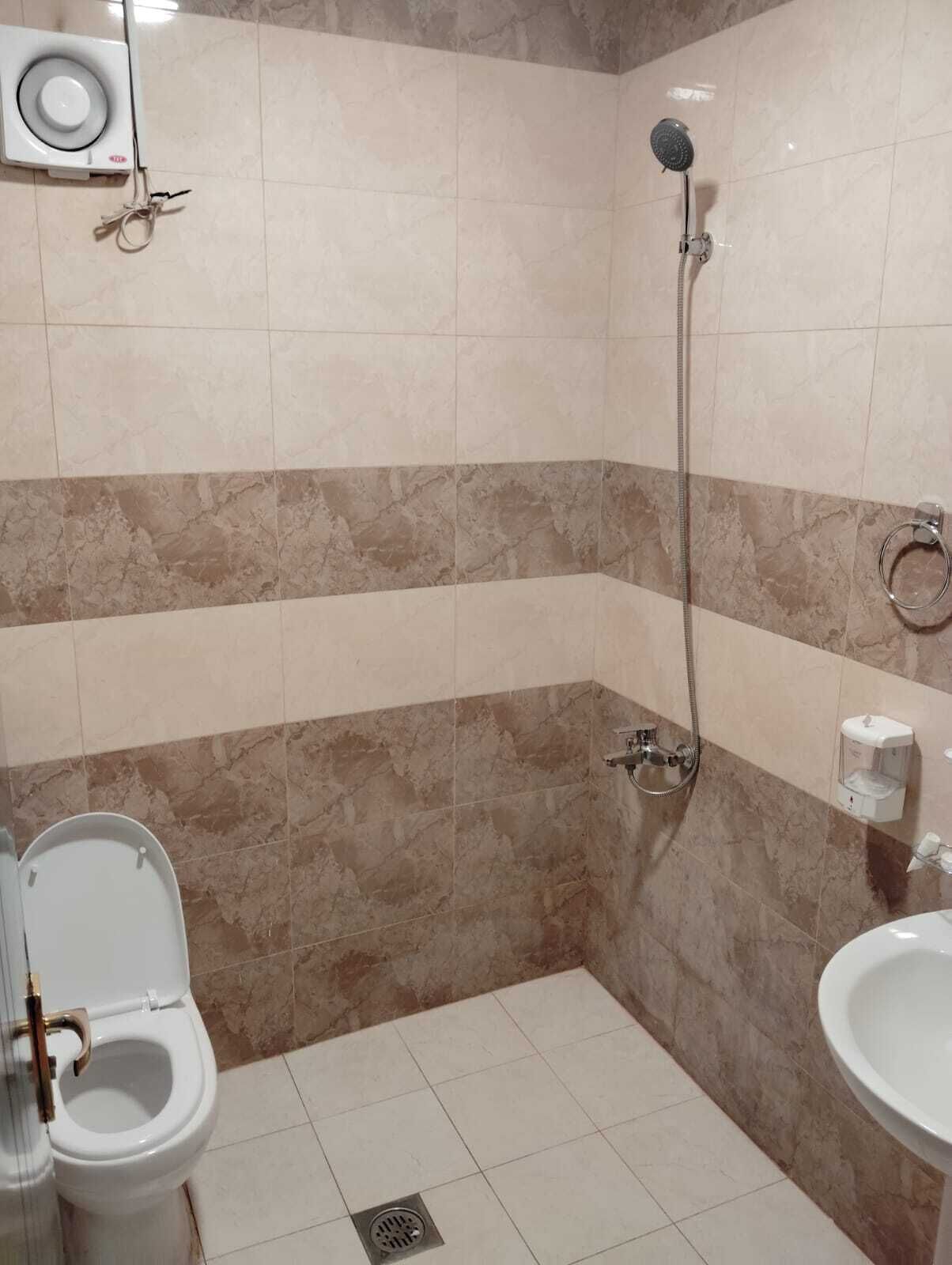 Shower, hair dryer, slippers, towels