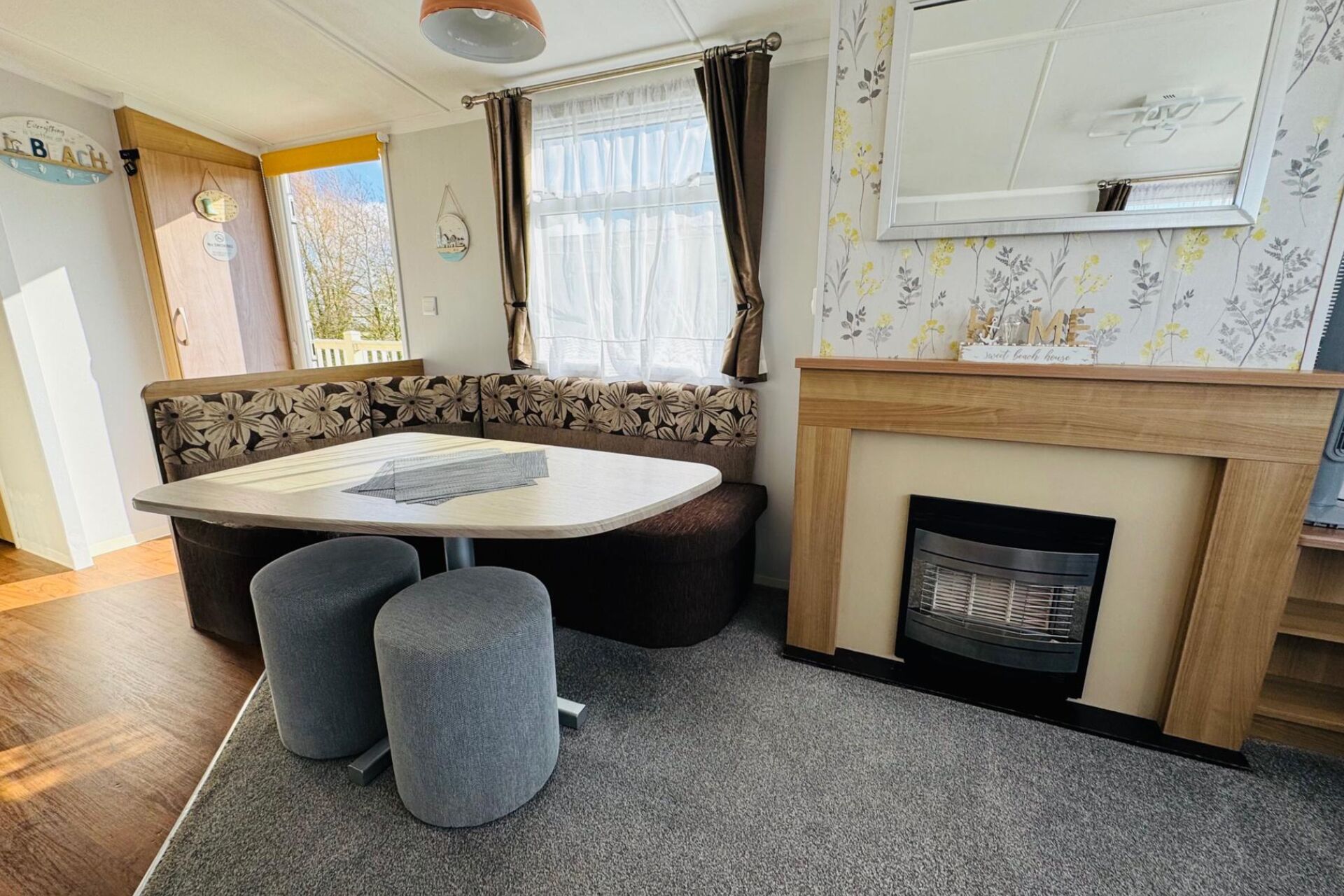 A cozy room with a sofa, a table, and a fireplace.