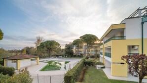 A modern hotel with a swimming pool, well-maintained gardens, and a clear view of the surrounding landscape. - Beautiful flat with large garden and terrace (Bibione)