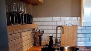 A kitchen with wooden countertops, a stainless steel sink, and white cabinets. - Apartment 2 pers Residence PISCINE Mandelieu La Napoule Beaches 15mn walk (Mandelieu-la-Napoule)