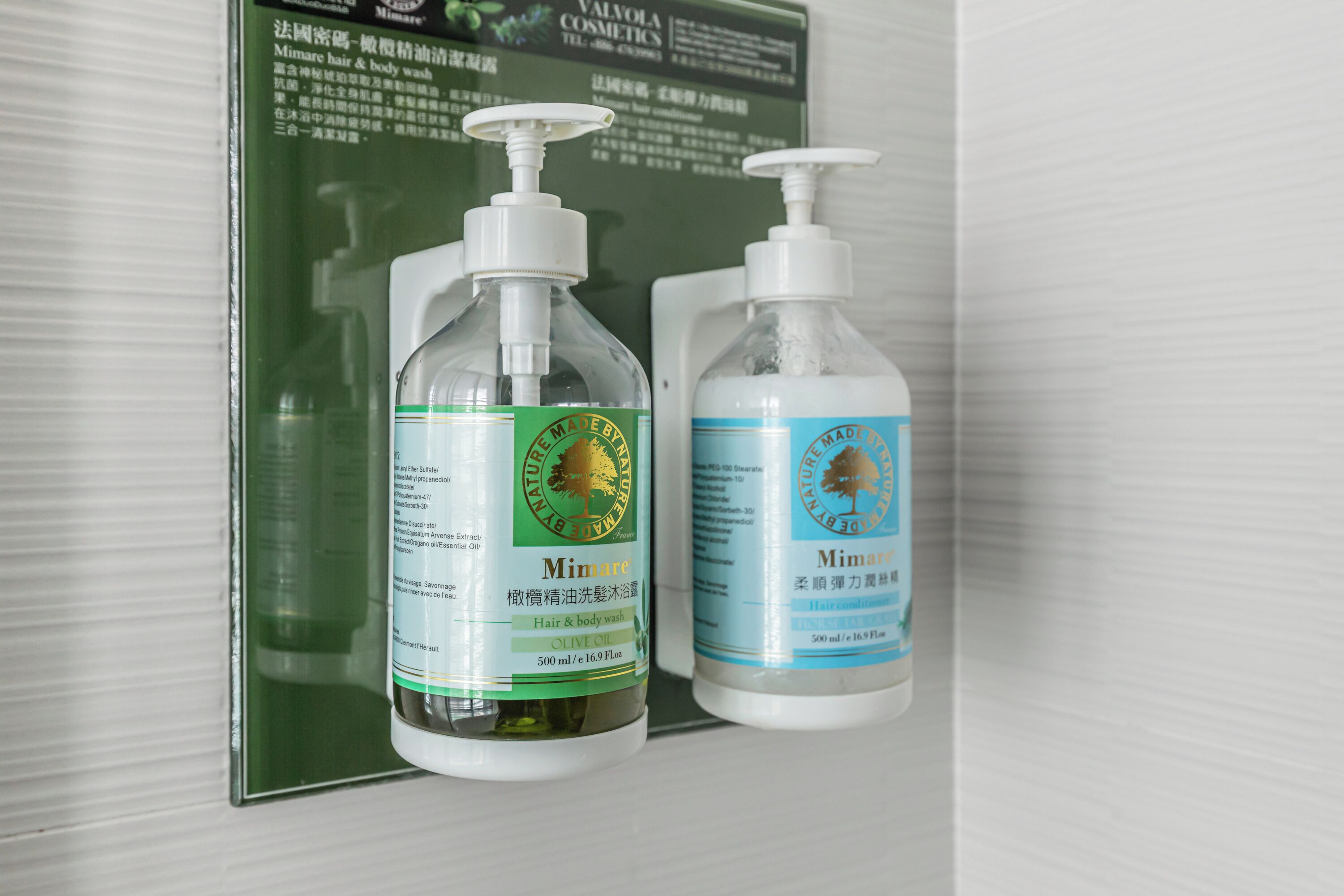 Two bottles of Mimare hair and body wash on a shelf.