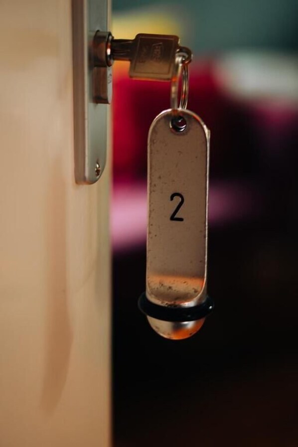 A door lock with a keyhole and a metal tag with the number 2.
