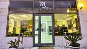 The exterior of the Margarita Hotel with a clear view of the entrance, including the hotel's name and logo. - Margarita Hotel Amman (Amman)