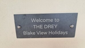 A welcome sign for THE DREY Blake View Holidays.