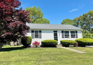 A single-story house with a front door, two windows, and a small porch. - Make this charming, modern retreat your home away from home!! (Wareham)