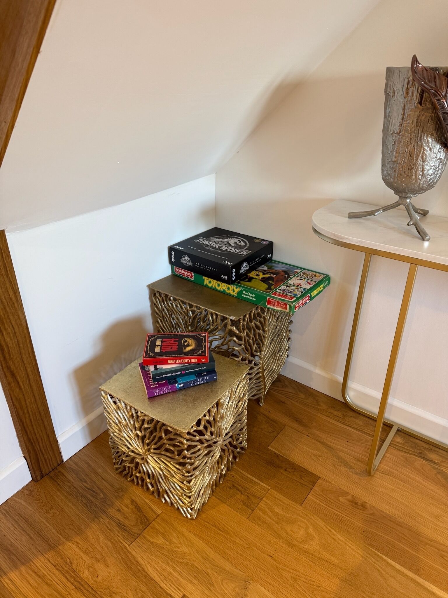 A staircase with three steps, each with a different book on top.
