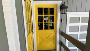 A yellow door with a glass panel and a small sign above it. - Quiet 1 Bdrm walk to beach & trails.  Close to ski areas. (Kings Beach)