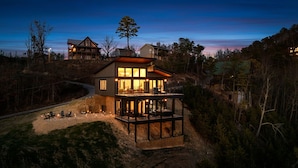 A two-story house with a deck and a large window overlooking a forested area. - VIEWS, VIEWS & more VIEWS! (Sevierville)