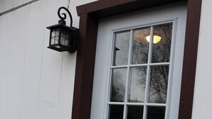 A white door with a brown frame, a glass panel, and a black lantern on the wall. - Mountain Paradise - a private guest suite in Flagstaff (Flagstaff)