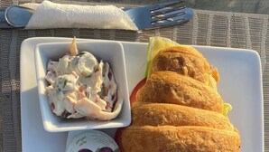 A plate with croissants, a bowl of salad, and two containers of yogurt. - Galleria Pyramids View Hotel (Giza)