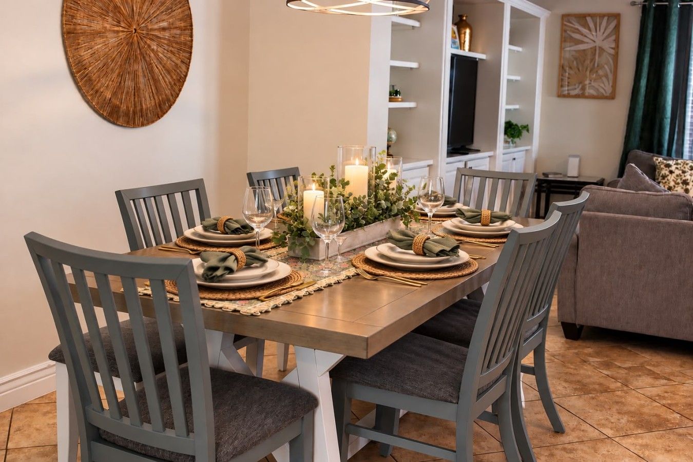 A dining area with a rectangular table set for four, surrounded by chairs with cushioned seats.