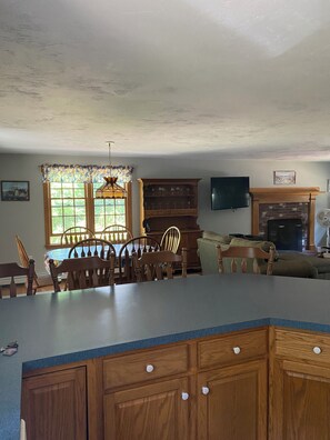 Enjoy cooking in this well-equipped kitchen with a large island countertop, stove, and dining table.