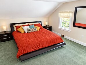 A bedroom with a bed, nightstands, a window with a view, and a mirror on the wall. - Lakefront Retreat. Firepit & Home Office.  Beautiful Sunsets & Great Ice Fishing (Constantia)