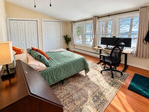 A bedroom with a bed, desk, computer, and large windows. - Lakefront Retreat. Firepit & Home Office.  Beautiful Sunsets & Great Ice Fishing (Constantia)