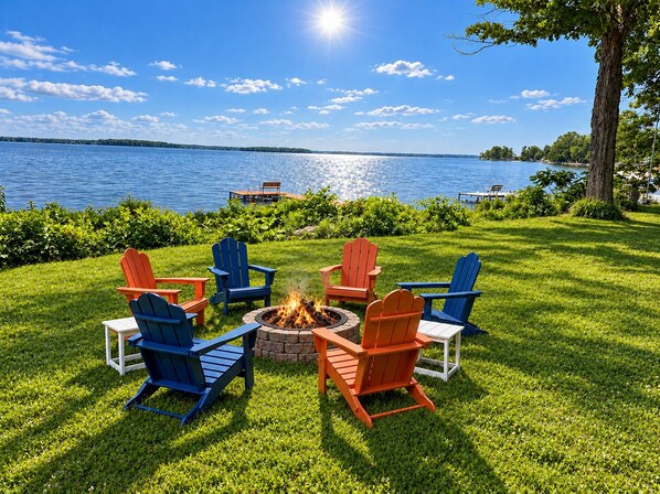 A lakeside outdoor seating area with a fire pit surrounded by Adirondack chairs. - Lakefront Retreat. Firepit & Home Office. Beautiful Sunsets & Great Ice Fishing (Constantia)