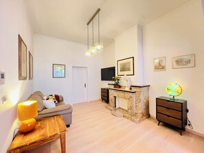 Relax in this stylish living space with a comfortable sofa, coffee table, and fireplace.