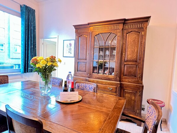 Enjoy meals in style at this elegant dining area, featuring a spacious table and comfortable seating.
