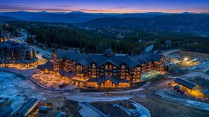 A large lodge with multiple stories, a ski lift, and a dining area with outdoor seating. - OSHP Gondola corridor — ski-in/ski-out at Peak 8 (Breckenridge)