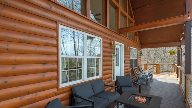 A log cabin with a deck featuring a fire pit and outdoor seating. - Deer Haven Cabin, Stunning Mtn Views, Hot Tub+Fire Table+Grill, Game Room, WiFi! (Burnsville)