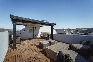 A rooftop terrace with wooden flooring, wicker furniture, and a pergola. - Zion's Sunset is BRAND NEW!!! Beautiful courtyard, fun game room, roof top deck (Hurricane)