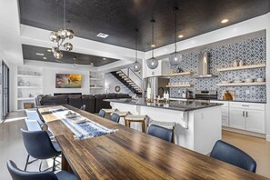 A modern kitchen with a central island, built-in appliances, and a patterned backsplash. - Zion's Sunset is BRAND NEW!!! Beautiful courtyard, fun game room, roof top deck (Hurricane)
