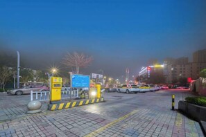 A parking area with barriers, a sign, and a paved surface. - Antai International Hotel (Zhongkai Bus Terminal Store) (Huizhou)