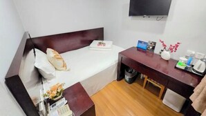 A compact hotel room with a single bed, a desk with a chair, a flat-screen TV mounted on the wall, and a small trash bin. - Jintai Home (Beijing North Railway Station Jiaotong University Branch) (Beijing)