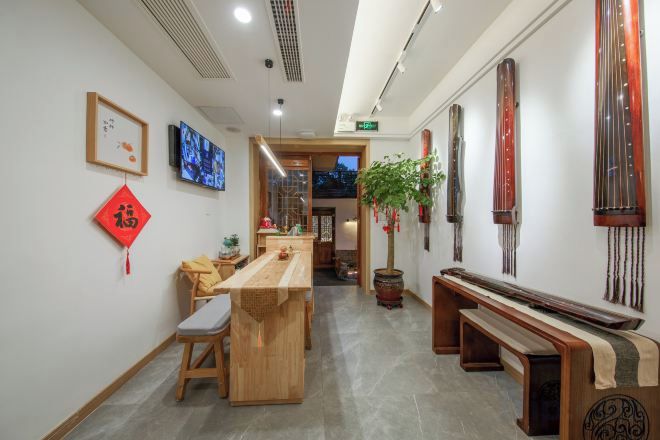 A reception area with a long wooden counter, seating, and traditional decor.