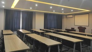 A conference room with multiple tables and chairs, a projector screen, and a podium. - 7 Days Premium (Zibo Zichuan Hongtai) (Zibo)