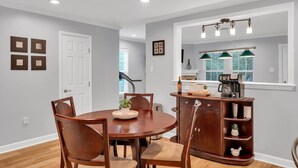 A dining area with a wooden table and chairs, a coffee machine, and a mirror above the counter. - Southern Charm: Streetcar, City Park, and French Q (New Orleans)