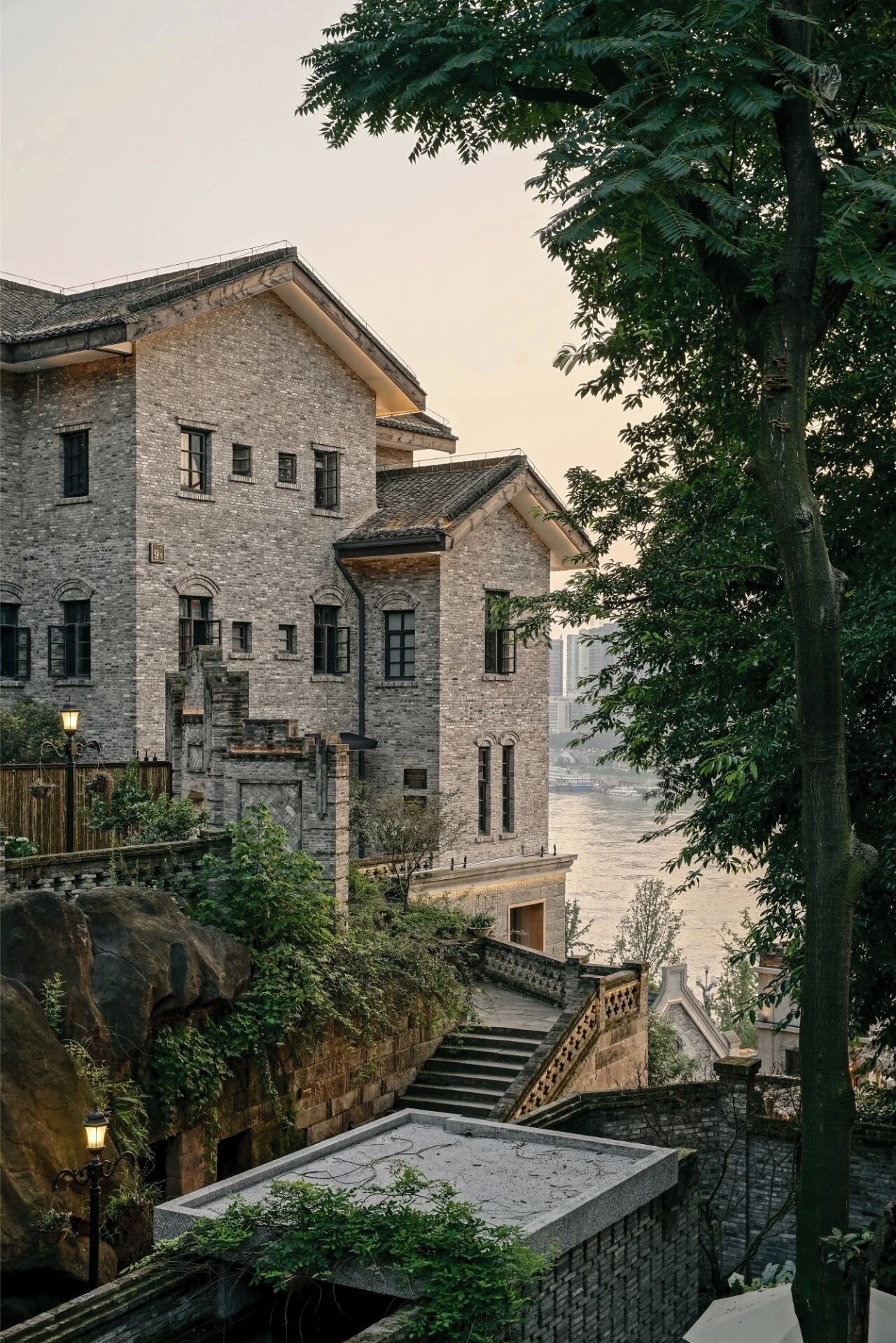 A multi-story stone building with a traditional design, featuring a staircase leading to an upper level.