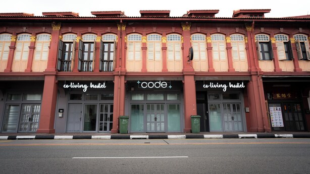 A row of traditional buildings with signage for 'co-living hotel' and 'code'. - Code Hostel at Kampong Glam (Singapore)