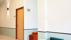 A hotel corridor with a reception, rooms, pantry, and laundry signs. - Code Hostel at Kampong Glam (Singapore)