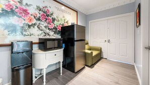 A kitchen with a refrigerator, microwave, and water dispenser. - Amy Guesthouse (Richmond)