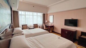 A hotel room with two beds, a desk with a chair, a television, and a large window. - VN hotel -Guangdong Heyuan Hongxing road (Heyuan)