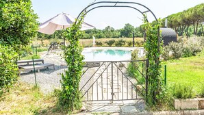 A gated pool area with a clear view of the pool, surrounded by greenery and a pergola. - Lavanda by Interhome (Fucecchio)