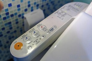 A remote control with multiple buttons, including a stop button, a power button, and a menu button. - MEISU Meisu Art Hotel (Ninghai Xizi International Branch) (Ninghai)